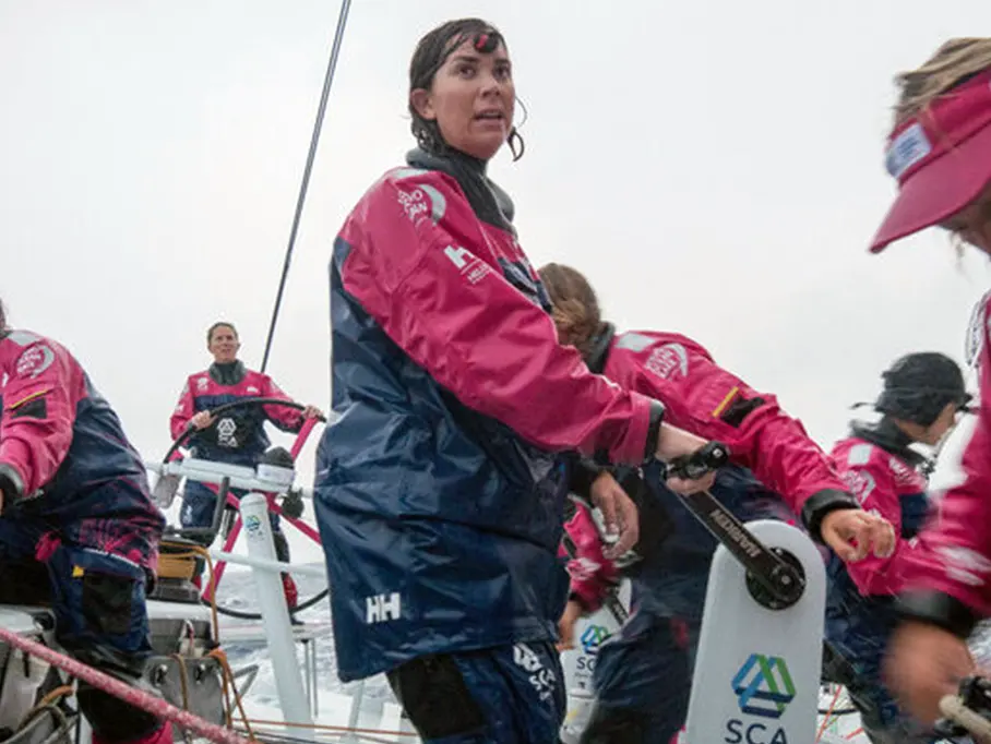 sara harstreiter on boat with crew in the rain